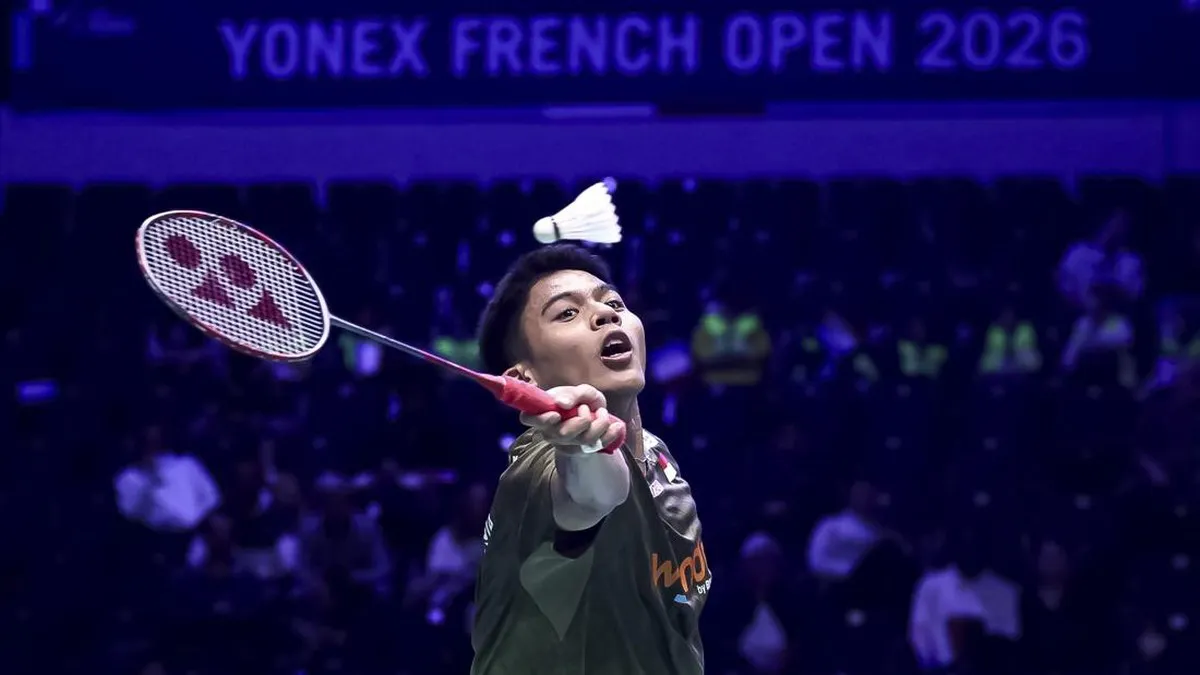 Badminton racket and shuttlecock beside a court