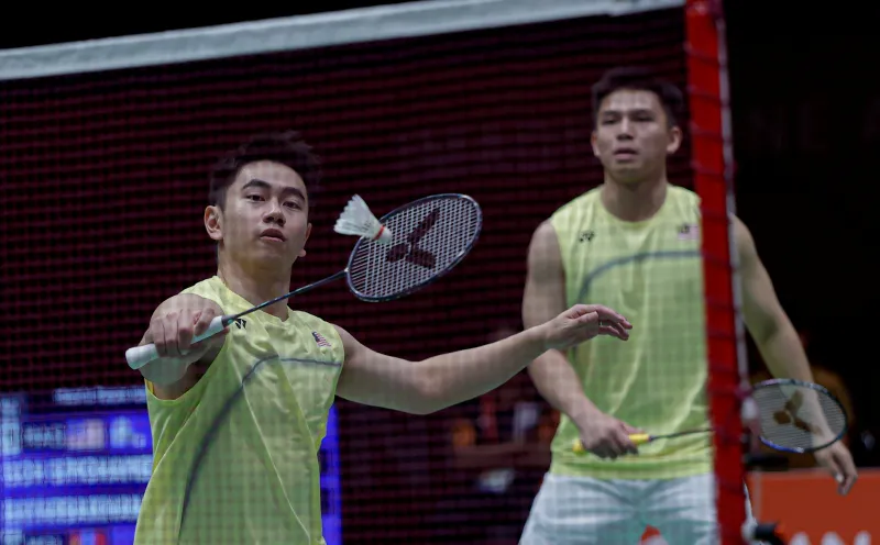 Badminton rackets and shuttlecocks beside an indoor court