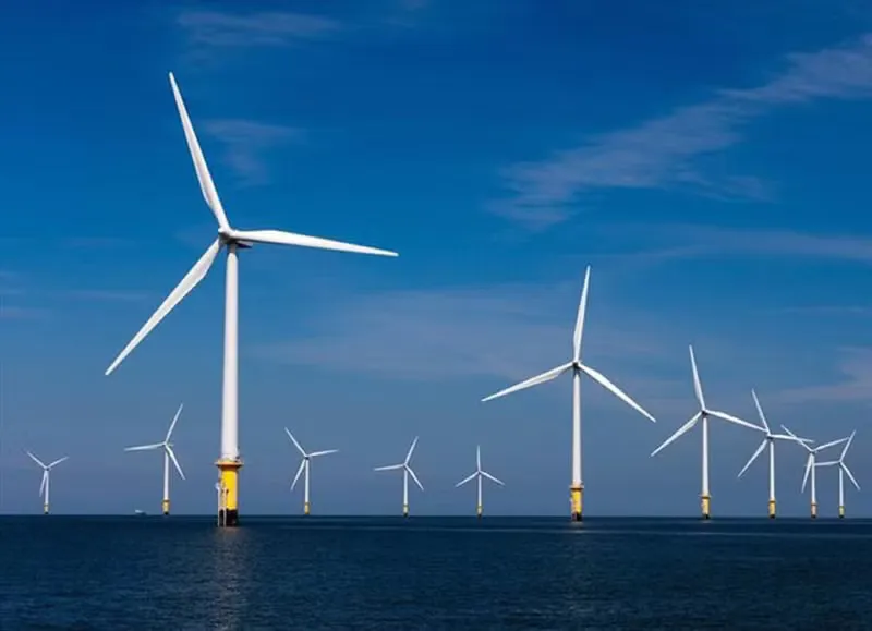 Offshore wind turbines standing in coastal waters