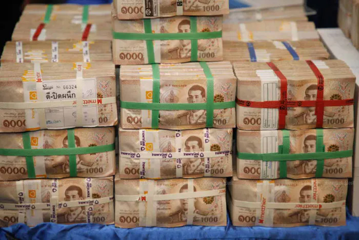 Cash and financial documents on a bank counter