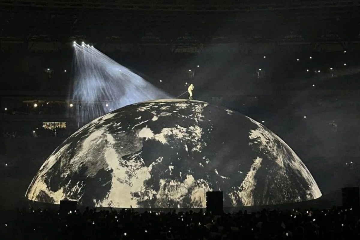 Concert stage lighting above a large audience