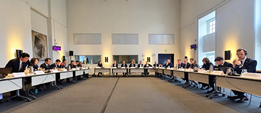 Conference table with microphones and Vietnamese and Danish flags