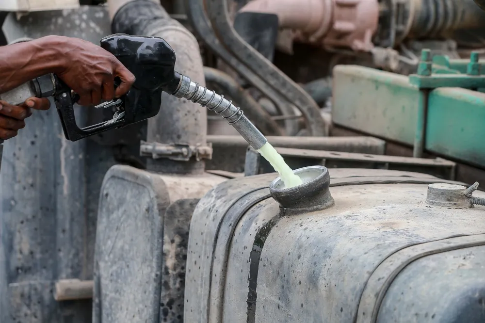 Diesel pump beside a pickup truck at a filling station