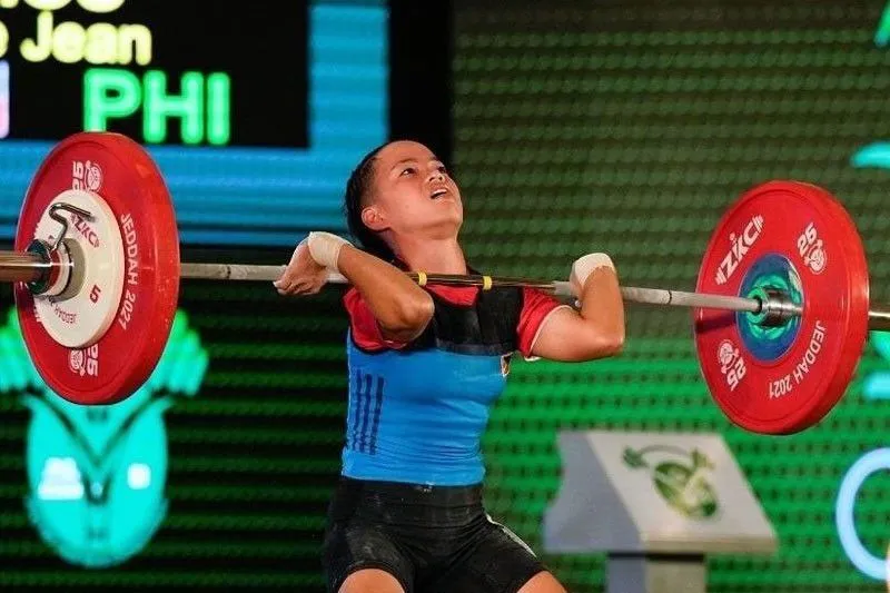 Weightlifting barbell and weight plates on a competition platform