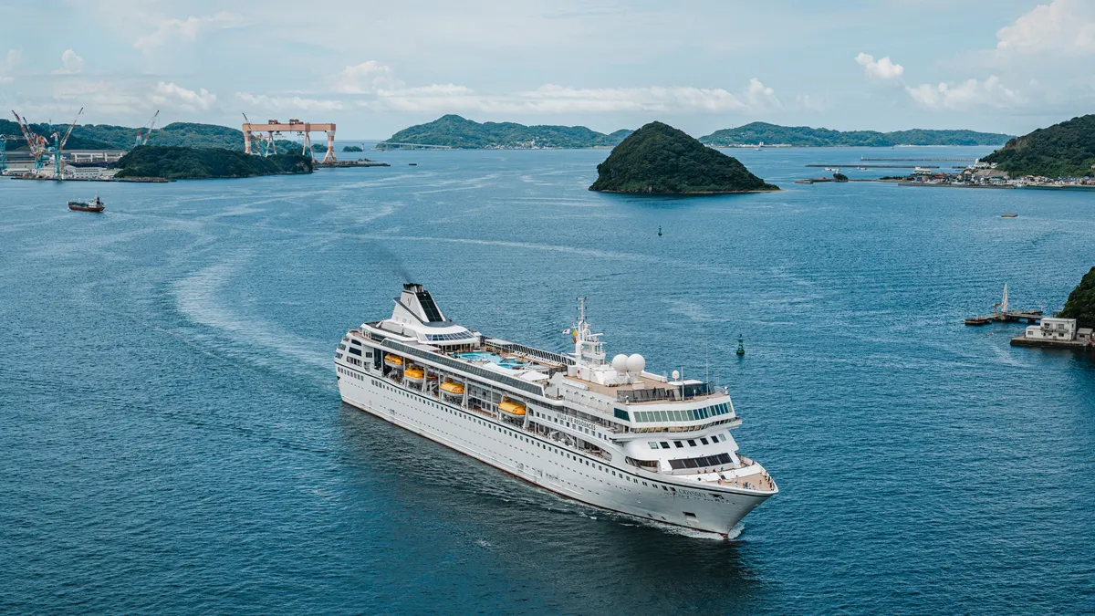 A cruise ship moored beside a port terminal