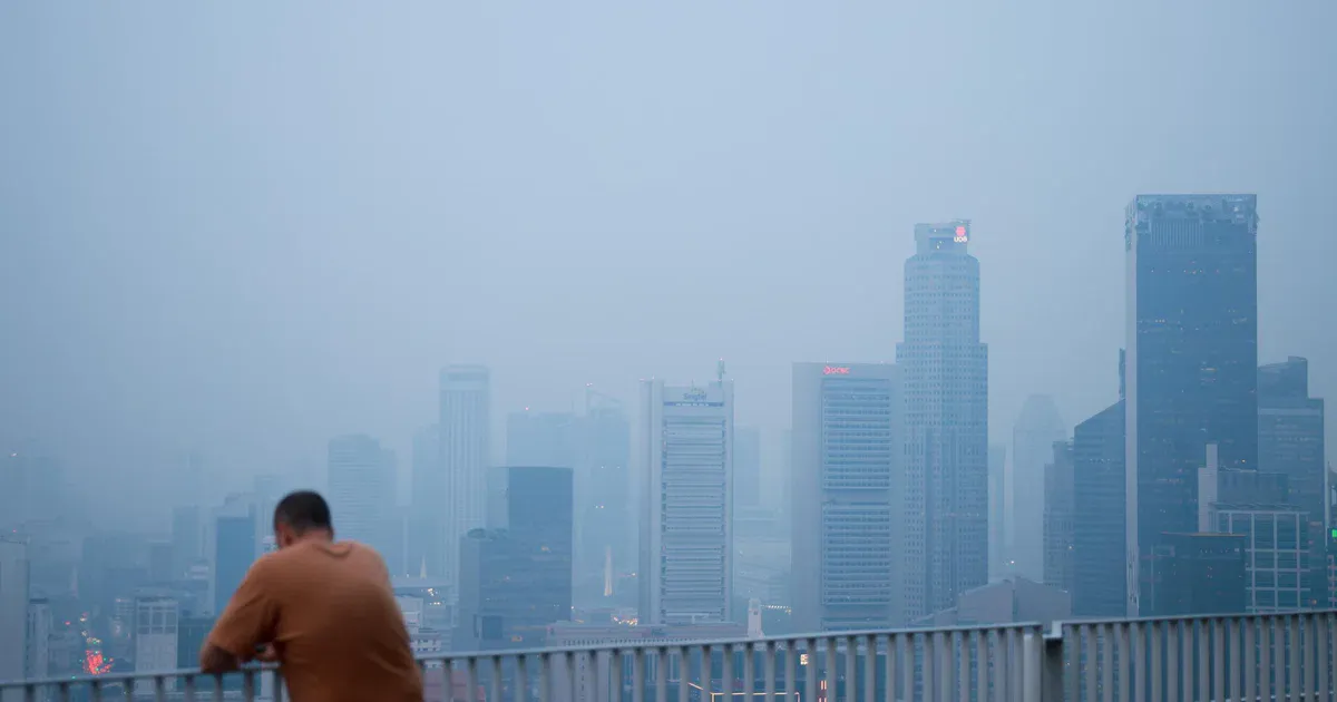 Singapore skyline beneath a hazy sky