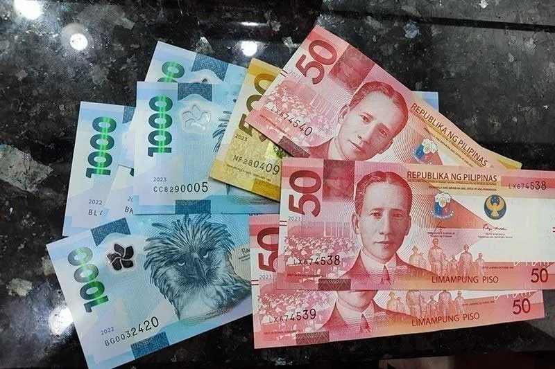 Philippine peso banknotes arranged on a desk