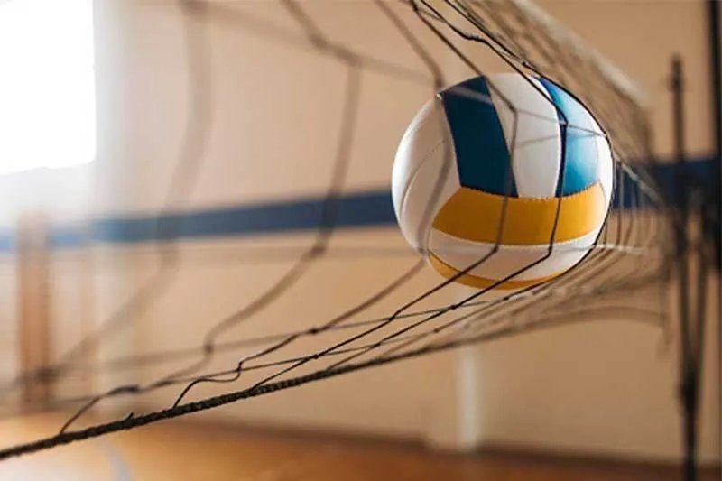 Volleyball net and court inside an indoor sports arena