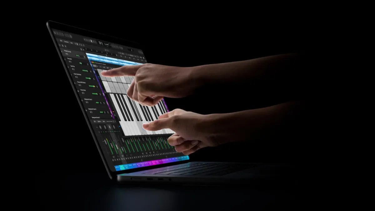 An open laptop with a keyboard, trackpad and illuminated display