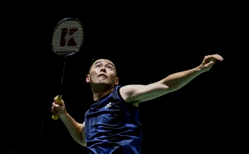 Badminton racket and shuttlecock beside a court