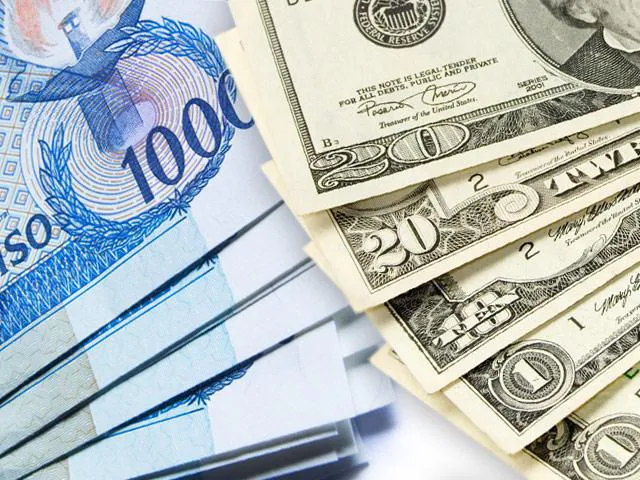 Philippine peso banknotes alongside US dollar banknotes