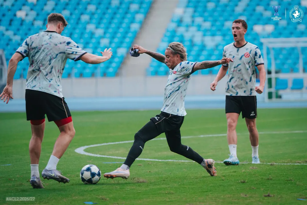 Football on a pitch under stadium floodlights