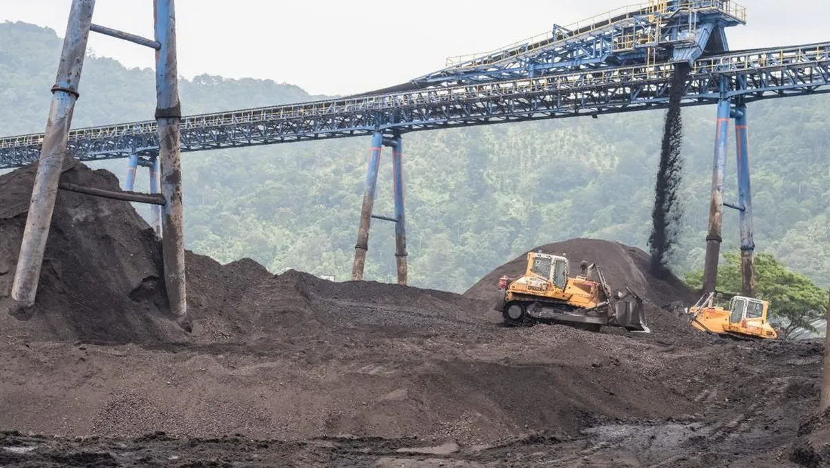 Coal stockpiles and mining equipment at an open-pit mine