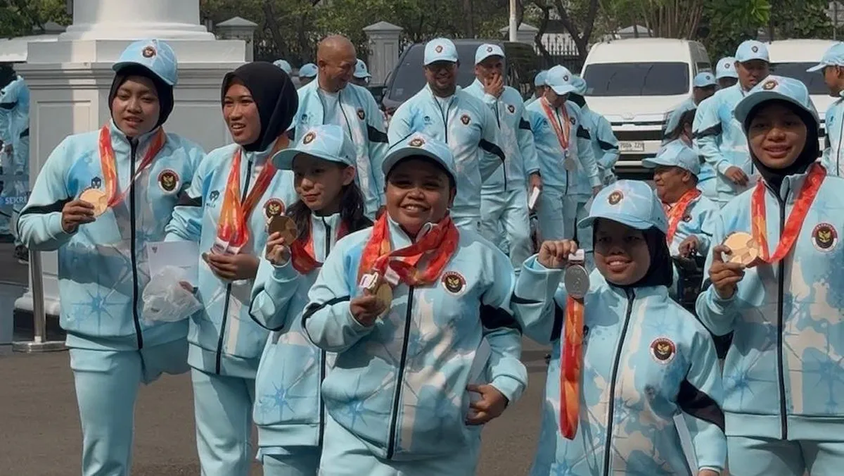 Medals arranged beside sports equipment