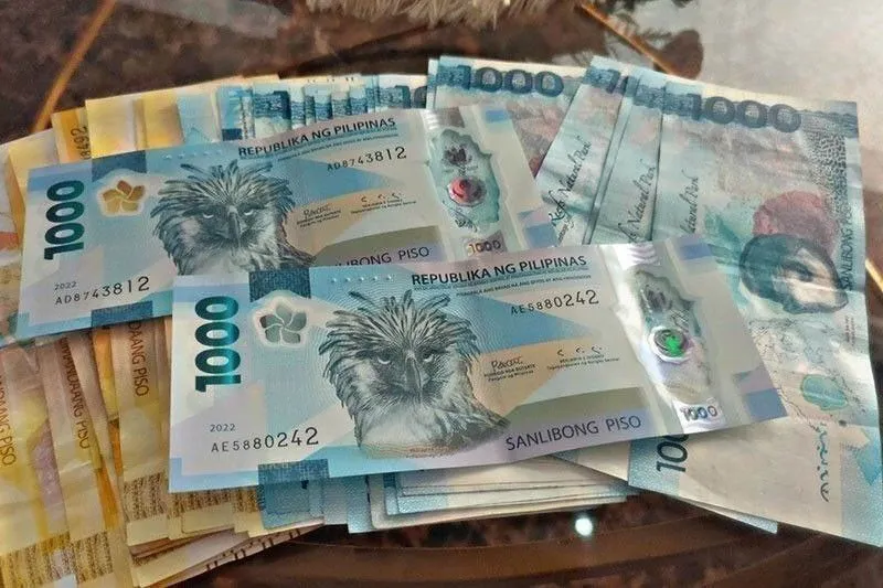 Philippine peso banknotes arranged on a desk