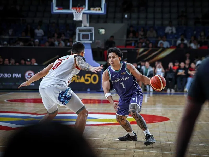 Basketball and hoop inside an indoor arena