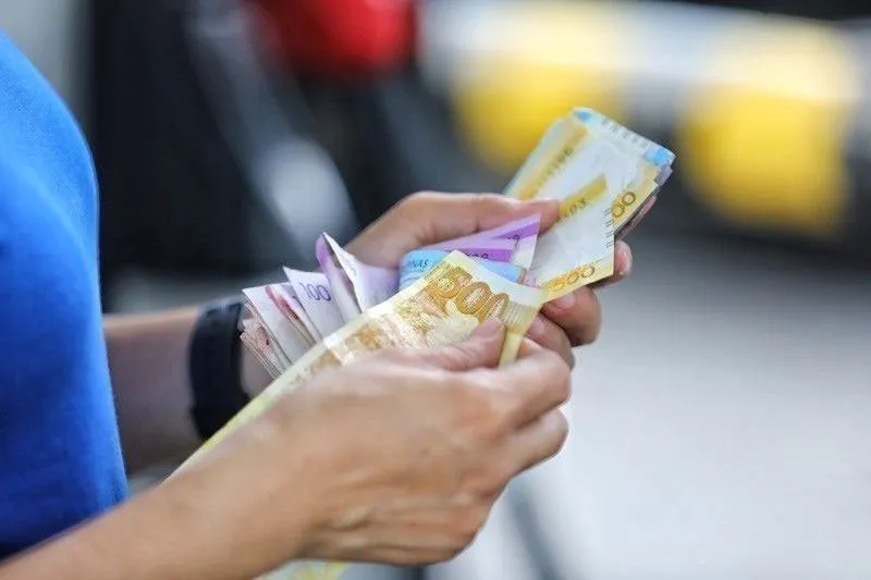 Philippine peso banknotes arranged on a table