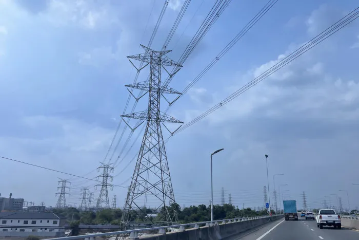 Solar panels beside electricity transmission infrastructure