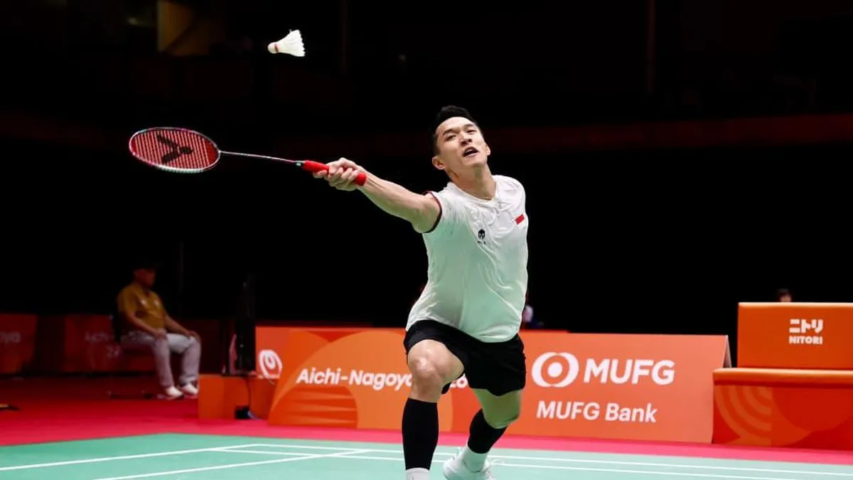 A shuttlecock beside a badminton racket on an indoor court