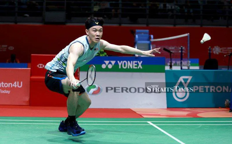 Badminton racket and shuttlecock beside a court