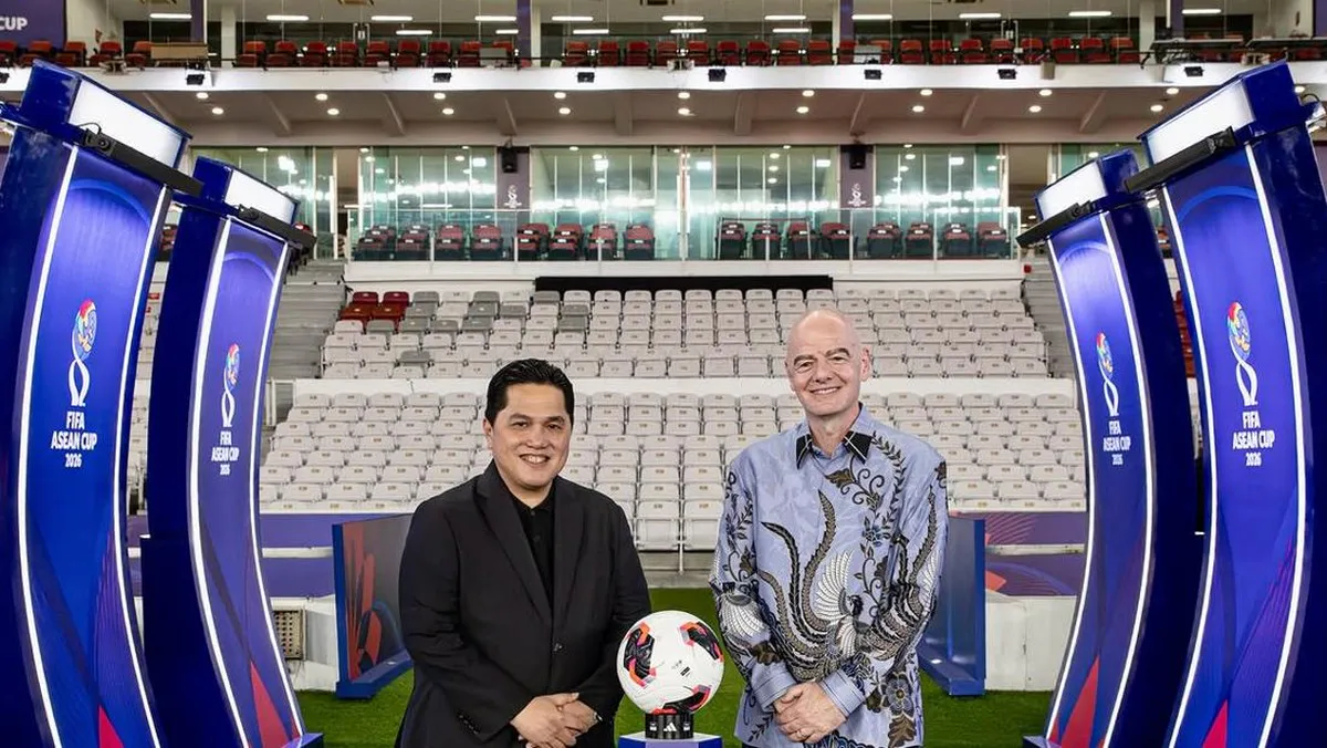 Football pitch and spectator stands inside a stadium