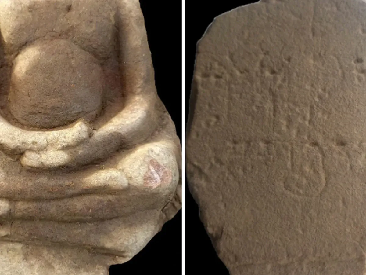 Sandstone sculpture and ceramic artefacts in a museum display