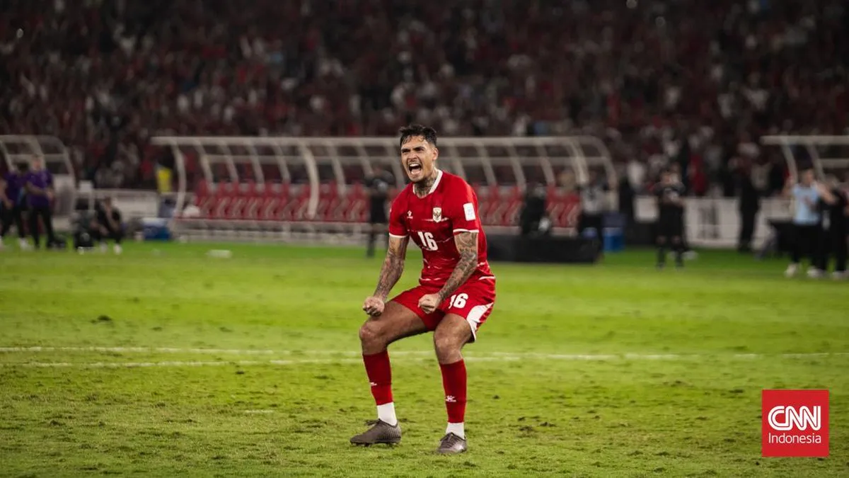 Football on the penalty spot facing a goal on a stadium pitch